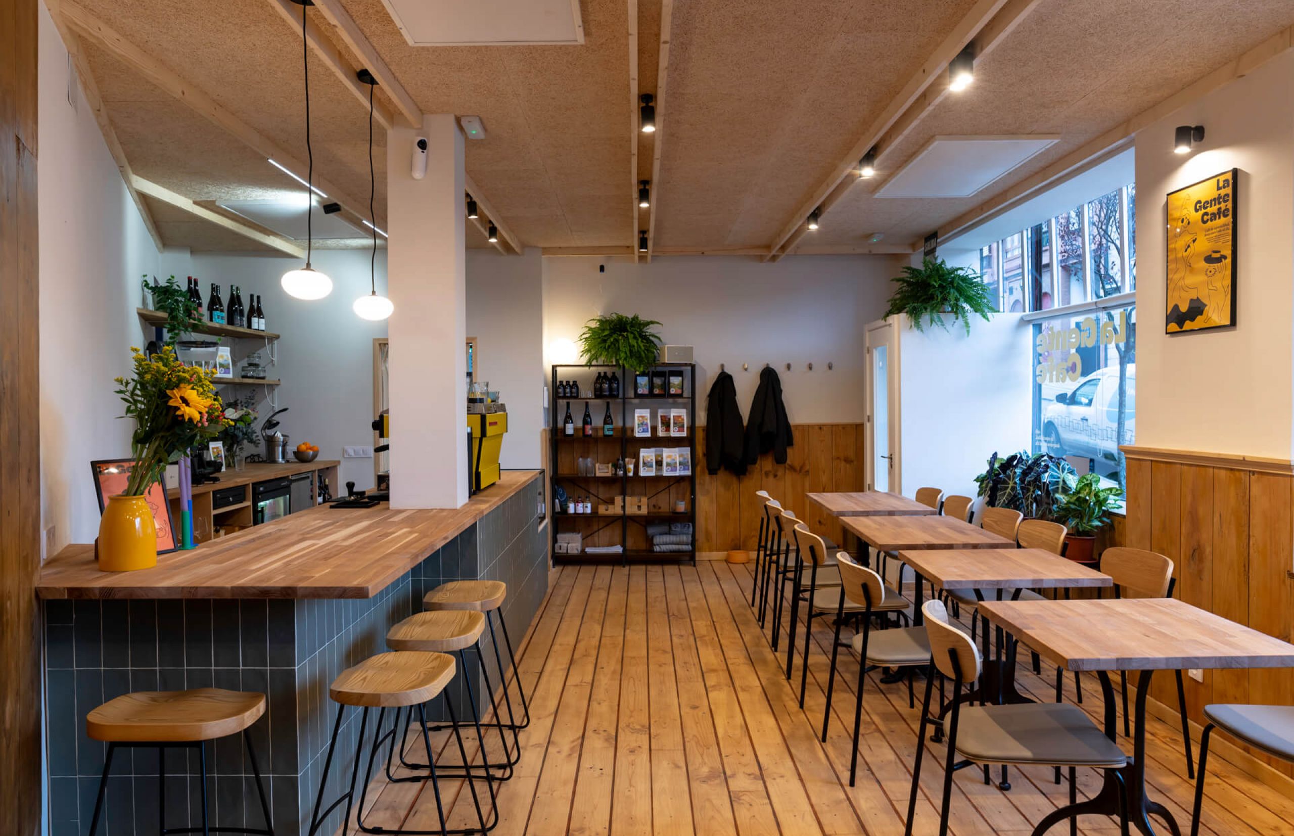 La Gente Cafe features a cozy interior with wooden floors and tables, designed by TenZeroTwo Bureau